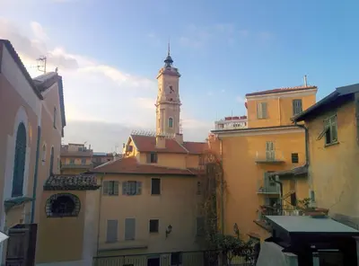 a building with a clock tower on top of it at Le 7 Augustin in Nice