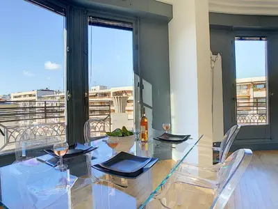 a dining room with a glass table and chairs at Nestor&Jeeves - LES AIGLES - Very close sea - Top floor - Luxurious in Nice
