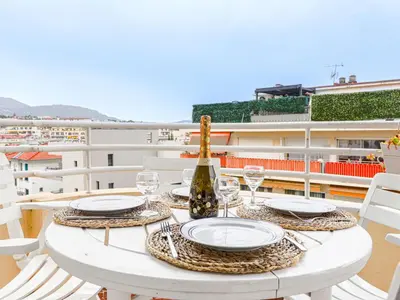 a white table with glasses and a bottle of wine at Apartment Saint Christophe by Interhome in Nice