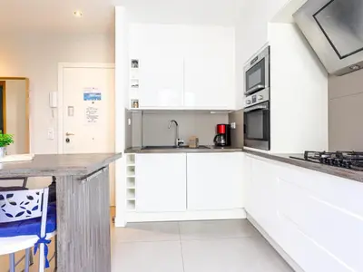 a kitchen with white cabinets and a counter at Apartment Saint Christophe by Interhome in Nice