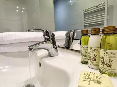 a bathroom sink with two bottles of soap and a mirror at Nestor&Jeeves - SUITE ROYAL LUXEMBOURG - Central - Swimming pool on roof in Nice
