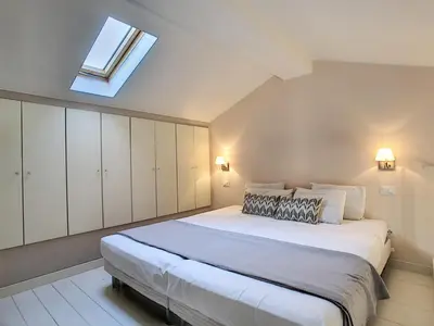 a bedroom with a large white bed with a skylight at Nestor&Jeeves - LE DUPLEX - Central - Very close sea in Nice