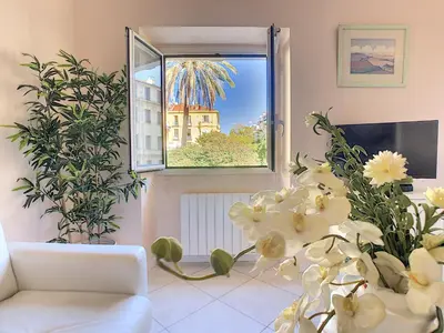 a living room with a white couch and a window at Nestor&Jeeves - LE DUPLEX - Central - Very close sea in Nice