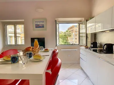 a kitchen with a table with red chairs and a counter at Nestor&Jeeves - LE DUPLEX - Central - Very close sea in Nice