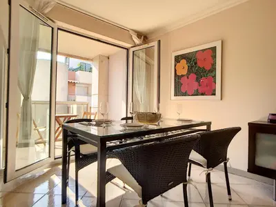 a dining room with a glass table and chairs at Nestor&Jeeves - PALAIS RENOIR - By sea - Free parking in Nice