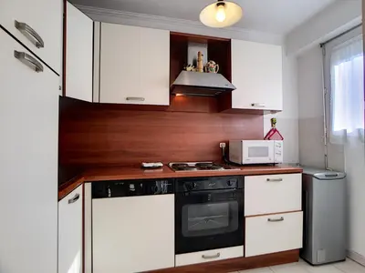 a kitchen with white cabinets and a stove top oven at Nestor&Jeeves - PALAIS RENOIR - By sea - Free parking in Nice