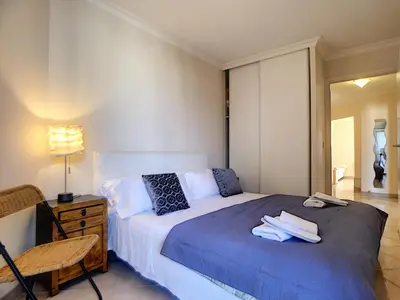 a bedroom with a bed with towels on it at Nestor&Jeeves - PALAIS RENOIR - By sea - Free parking in Nice