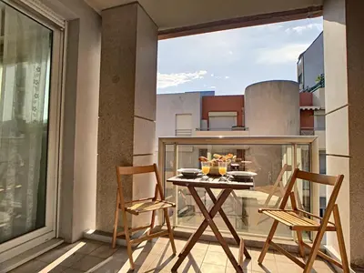 a balcony with a table and chairs on a balcony at Nestor&Jeeves - PALAIS RENOIR - By sea - Free parking in Nice