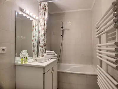 a bathroom with a sink and a bath tub at Nestor&Jeeves - PALAIS RENOIR - By sea - Free parking in Nice
