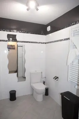 a bathroom with a white toilet in a room at Villa Lympia in Nice