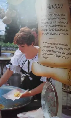 a picture of a woman preparing food in a kitchen at Villa Lympia in Nice
