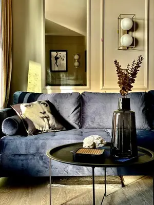 a blue couch with a table in a living room at Unique Apartment - Costa Plana in Cap d'Ail