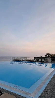 a large swimming pool with the ocean in the background at Unique Apartment - Costa Plana in Cap d'Ail