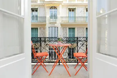 a table and chairs in front of a building at La Romantica Dante Five stars Holiday House in Nice