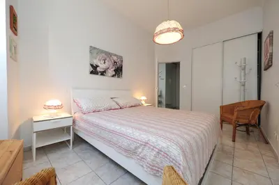 a bedroom with a bed and a table and a chair at La Romantica Dante Five stars Holiday House in Nice