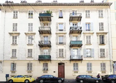 a large white building with cars parked in front of it at La Romantica Dante Five stars Holiday House in Nice