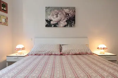 a bedroom with a bed with two lamps on tables at La Romantica Dante Five stars Holiday House in Nice