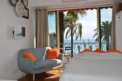 a bedroom with a bed and a view of the ocean at Le Grand Sud in Nice