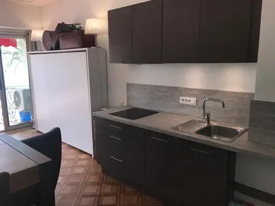 a kitchen with a sink and a refrigerator at Le Grand Sud in Nice