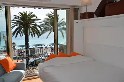 a bedroom with a bed and a view of the ocean at Le Grand Sud in Nice