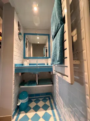 a bathroom with a blue sink and a mirror at Les Grimaldines - Maison d'Hôtes in Cagnes-sur-Mer