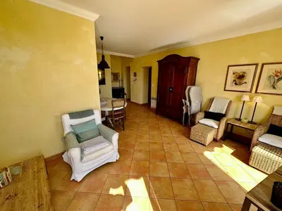 a living room with chairs and a table at Résidence Place Poullan in Villefranche-sur-Mer