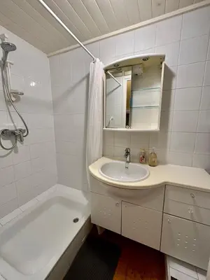 a white bathroom with a sink and a bath tub at Résidence Place Poullan in Villefranche-sur-Mer