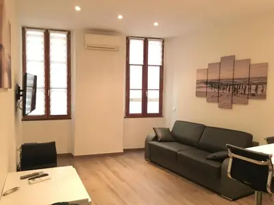 a living room with a couch and a table at Gallo Comfort in Nice