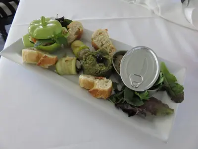 a plate of food with vegetables and bread on a table at Hotel mon Soleil in La Gaude