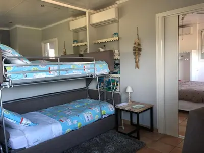 a bedroom with two bunk beds and a mirror at Villa les grimaldines côte d Azur in Cagnes-sur-Mer
