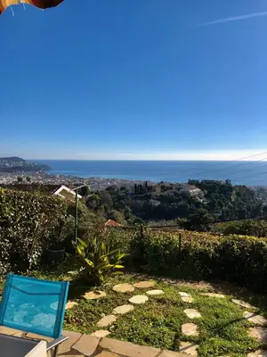 a chair sitting on a hill with the ocean in the background at Bellevue in Nice