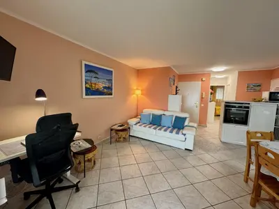 a living room with a couch and a kitchen at Bellevue in Nice