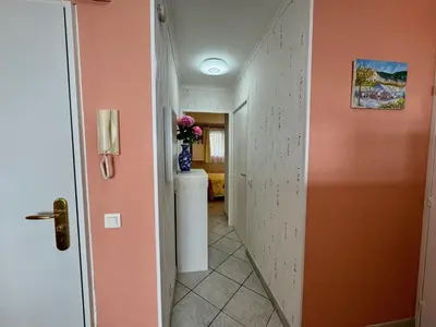 a hallway with a vase of flowers on a counter at Bellevue in Nice