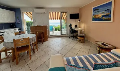 a kitchen and a living room with a table and a dining room at Bellevue in Nice