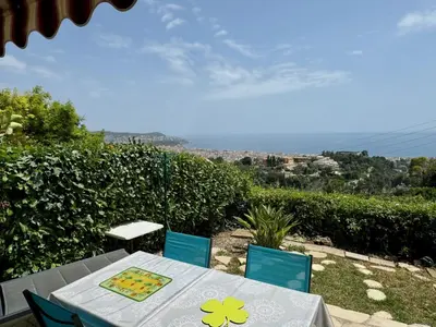 a table and two chairs with a table and a view at Bellevue in Nice