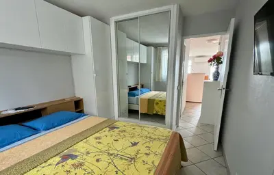 a small bedroom with a bed and a mirror at Bellevue in Nice