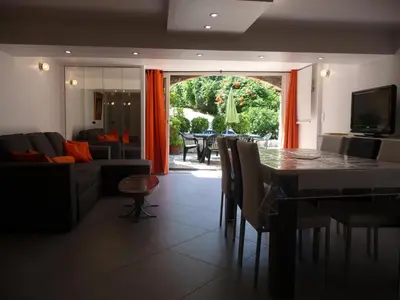 a living room with a table and a couch at Appartement Castagniers in Castagniers