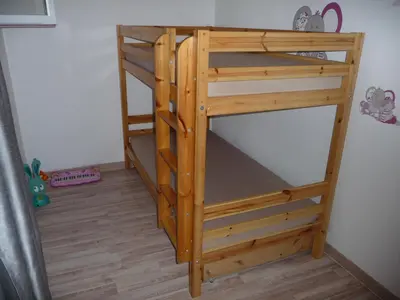 a wooden bunk bed in the corner of a room at Appartement Castagniers in Castagniers