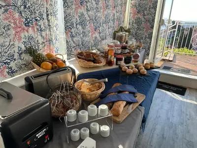 a table with bread and baskets of food on it at Hôtel La Fiancée du Pirate in Villefranche-sur-Mer