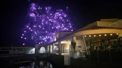 a firework display behind a building at night at Hôtel La Fiancée du Pirate in Villefranche-sur-Mer