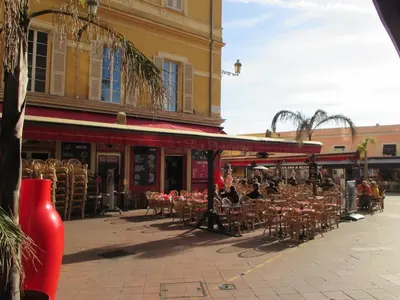 a street with tables and chairs in front of a building at Nice Apartment Old Town in Nice