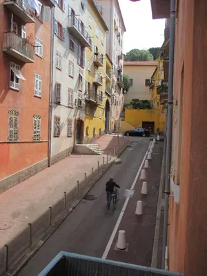 a man riding a bike down a street at Nice Apartment Old Town in Nice