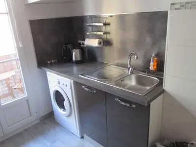 a kitchen with a sink and a washing machine at Nice Apartment Old Town in Nice
