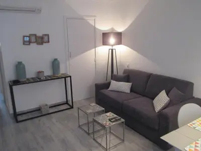 a living room with a couch and a table at Nice Apartment Old Town in Nice