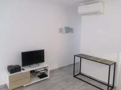 a living room with a television and a table at Nice Apartment Old Town in Nice