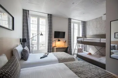 a bedroom with two beds and a bunk bed at Hotel Saint Gothard in Nice