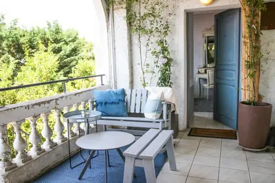 a porch with a bench and tables on a balcony at Le Panoramic Boutique Hôtel in Nice