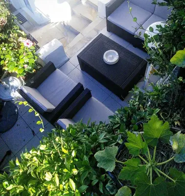 a table and chairs on a patio with plants at Le Panoramic Boutique Hôtel in Nice