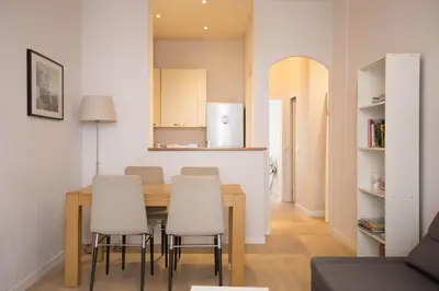 a kitchen and dining room with a table and chairs at Le Coin Du Marché in Nice