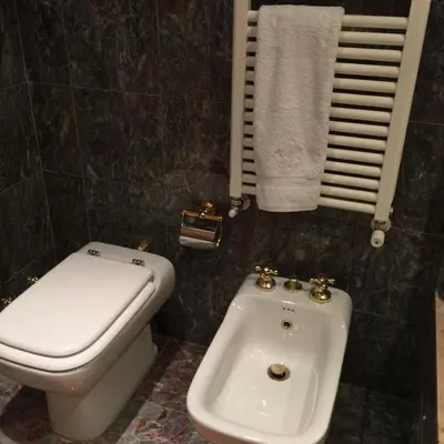 a bathroom with a toilet and a bidet and a sink at Sunny Panoramic Balcony in Èze
